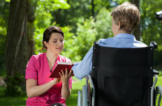 Elder-in-wheelchair-with-caregiver